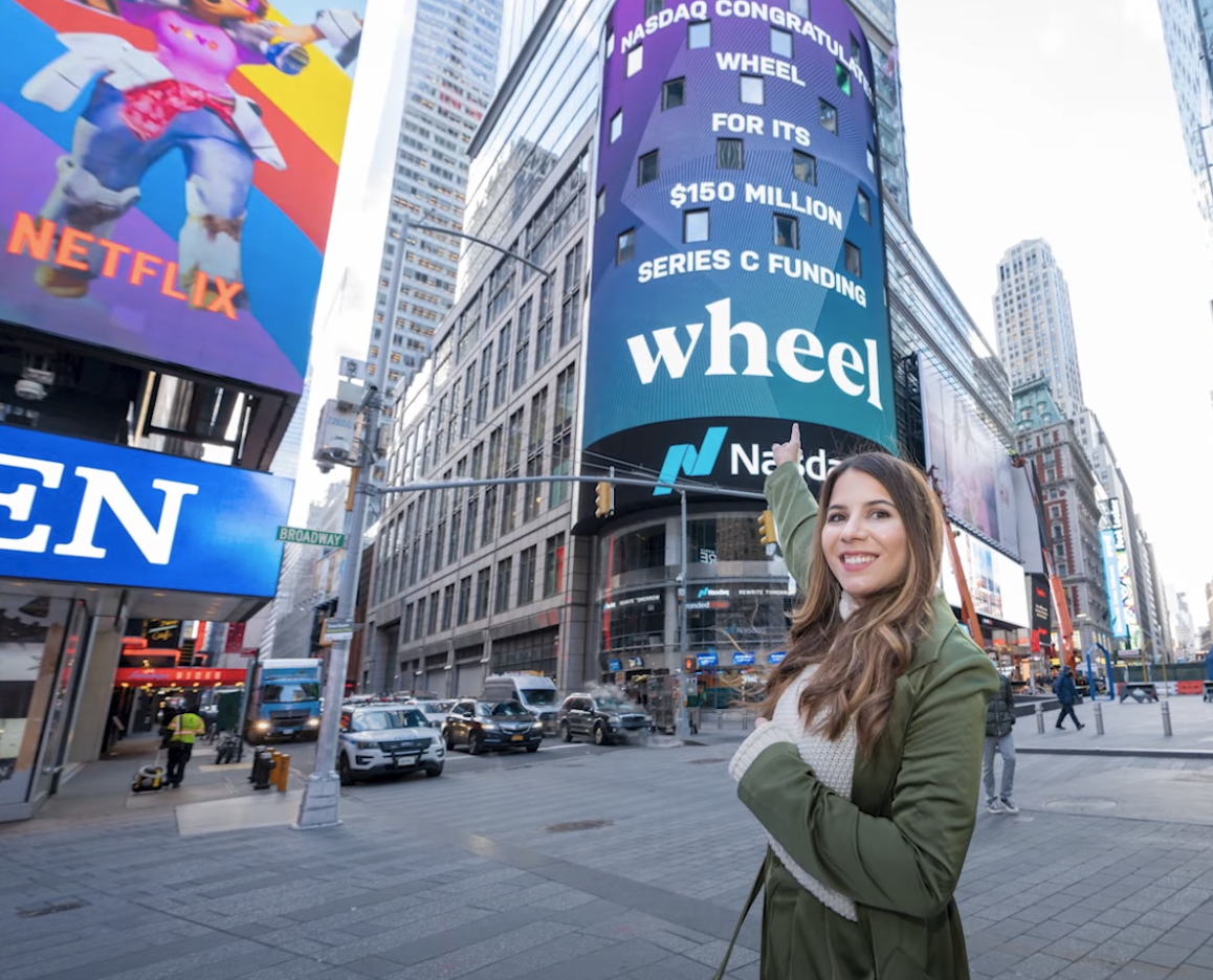 Michelle in front of Nasdaq sign